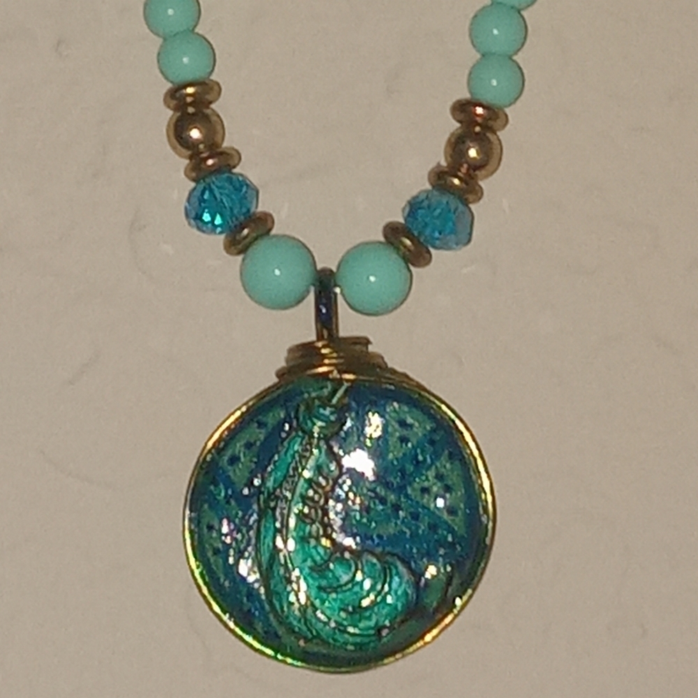 Blue green feather emblem necklace